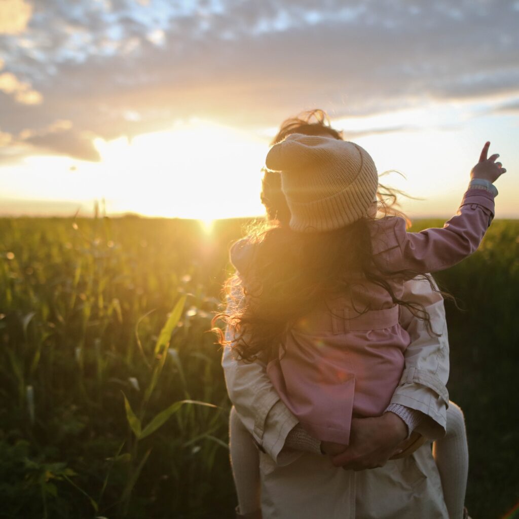 A mother and daughter walking in nature.